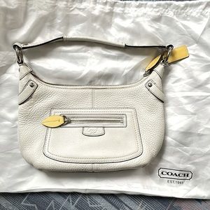 White Coach handbag with yellow leaf features. Pink interior. Very gently used.